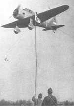 Ki-36 aircraft in flight over an airfield, circa 1940s