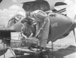 USAAF armorer 1st Lieutenant H. A. Blood examining the 20mm cannon ammunition of P-38 Lightning aircraft 