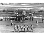 US Army aviator Lieutenant Peddy posing in front of his B-25 Mitchell bomber with his full crew, date unknown