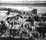 Wounded from Battle of Midway being offloaded from a C-53 variant of C-47 aircraft at Hickam Field, Oahu, US Territory of Hawaii, 7 Jun 1942; note Jeep and WC-9 ambulance