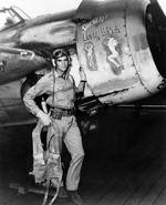 Ensign Darrell Bennett stood beside his FM-2 Wildcat 