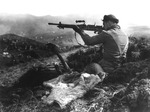 A Canadian soldier inspecting a captured Japanese Type 96 machine gun, Kiska, Aleutian Islands, US Territory of Alaska, 16 Aug 1943