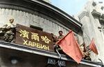 Soviet troops flying the red flag atop the train station at Harbin, Songjiang, China, circa 20 Aug 1945, photo 1 of 2