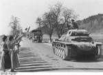 German Panzer II tank commander waving to Austrian women, Austria, 13 Mar 1938