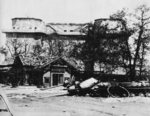 The Berlin Zoo flak tower after the battle, Germany, 1945; note two destroyed IS-2 tanks in foreground