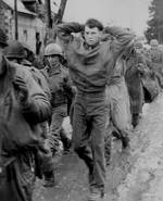 American prisoners marching along a road somewhere on the western front, Dec 1944