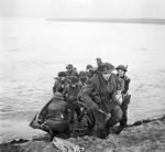 Men of the UK 15th Scottish Division leaving their assault craft after crossing the Rhine River near Xanten, North Rhine-Westphalia, Germany, 24 Mar 1945