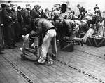 Armorers preparing the Doolittle Raid bombers aboard USS Hornet, 18 Apr 1942, photo 2 of 3