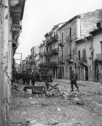 Troops of Canadian Loyal Edmonton Regiment and tank of Canadian Three Rivers Regiment, Ortona, Italy, 20-28 Dec 1943