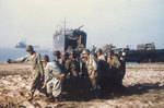 With LST-1 in background, US Army Engineers hauled a roll of wire mesh into position to make a beach roadway, Salerno, Italy, Sep 1943