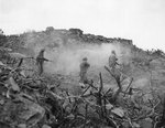 Four US Marines cleared out a cave with BAR, small arms, and grenades, Iwo Jima, circa Feb-Mar 1945