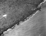 Aerial photo of wrecked American landing craft at Iwo Jima Beach, 21 Feb 1945