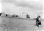 A Japanese-American farmer and his daughter taking a look of their strawberry farm before being relocated, Bainbridge Island, Washington, United States, 23 Mar 1942