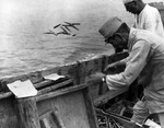 Japanese ammunition being thrown into the sea, 21 Sep 1945