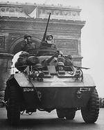 M8 Greyhound armored car of US Army 102nd Cavalry Reconnaissance Squadron passing under the Arc de Triomphe, Paris, France, 29 Aug 1944