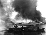 Japanese vessels burning at a harbor near Garapan, Saipan, Mariana Islands, Jun 1944