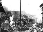 US Marines running through streets of Garapan while engaging in street fighting, Saipan, Mariana Islands, 3 Jul 1944