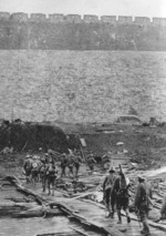 Japanese soldiers crossing a canal or moat near the Nanjing city wall, China, Dec 1937