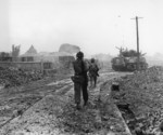 Americans walking through the ruins of Naha, Okinawa, Japan, May 1945