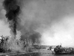 First wave of American troops storming ashore from amphibious landing craft, Leyte, Philippine Islands, 20 Oct 1944, photo 3 of 3