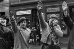 A Sudeten German woman crying in misery as she gave the Nazi Party salute while two others saluted with happiness, Cheb, Czechoslovakia, 5 Oct 1938