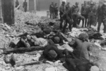 SS troops rounding up Jews near the intersection of Nowolipie Street and Smocza Street, Warsaw, Poland, Apr-May 1943