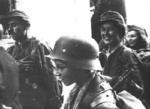 Resistance fighters Tadeusz Rajszczak (young boy in foreground), Henryka Zarzycka-Dziakowska (woman behind Rajszczak), and others near Nowy Swiat Street, Warsaw, Poland, early morning of 2 Sep 1944