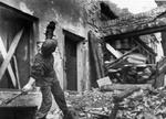 Polish resistance fighter Jerzy Siwiec throwing a German Model 24 grenade at Slepa Street in the Old Town section of Warsaw, Poland, late Aug 1944