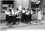 Members of the League of German Girls putting up recruiting posters, Worms, Germany, 1933-1945