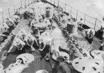 Japanese Navy sailors scrubbing the deck of a ship, circa 1940s