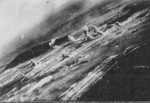 View of Toshien (now Zuoying) harbor and airfield, Takao (now Kaohsiung), Taiwan, 12 Oct 1944, photo 1 of 3; photo taken from aircraft of USS Wasp