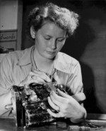 Female US Marine Private First Class Vera M. Cooper working on a carburetor, circa 1945