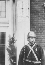 Japanese Special Naval Landing Force infantryman guarding a building his unit had just seized, Shanghai International Settlement, China, 8 Dec 1941