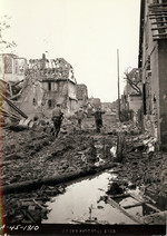 US soldier marching two captured Germans in a ruined town, Germany, 1944-1945; note the film used was Agfa Superpan Press