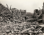 A US soldier walking through a destroyed German town, 1944-1945