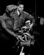 African-American factory workers Cecil M. Coles and Juanita E. Gray working on a lathe machine, which the latter was being trained to use, Washington, DC, United States, date unknown