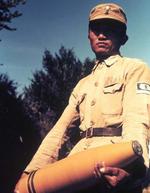 Chinese artilleryman carrying a shell, China, circa 1940s