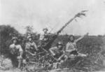 Chinese anti-aircraft crew with a camouflaged gun, China, circa 1940s