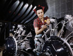 American woman working on an aircraft engine at a North American Aviation plant in California, United States, Jun 1942