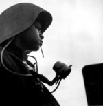 US Navy African-American Richard Salter, talker of a gun station aboard escort carrier USS Tulagi, off Southern France, Aug 1944