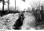 German soldier at Breisach am Rhein, Germany, 1940; note St. Stephansmünster cathedral in background