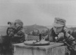 Women of the Lotta Svärd organization on air raid warning duty atop a tower, Finland, 1941; note Uskela church in background