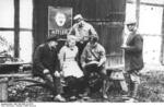 Nazi Party members gathering before an election poster featuring Adolf Hitler, summer of 1932