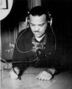 African-American US Coast Guard Radioman 3rd Class Joseph K. Noel performing work aboard a frigate in the North Pacific, date unknown