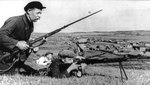 Soviet guerilla fighters on a hill overlooking a village, date unknown