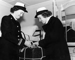 WAVES Lieutenant (Junior Grade) Margaret Kyle and Lieutenant (Junior Grade) E. C. Day unpacking in their stateroom while en route to Pearl Harbor, US Territory of Hawaii, 1945