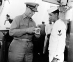 Admiral Arleigh Burke and a Third Class Quartermaster on bridge of destroyer Picking, circa 1955-1961