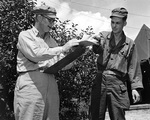 Rear Admiral Burke reading dispatches at the United Nations