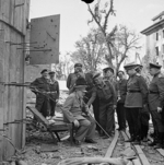 Churchill sitting in a damaged chair taken out from Hitler