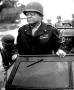 African-American US Army Brigadier General Benjamin O. Davis, Sr. watching a Signal Corps crew erecting poles, France, 8 Aug 1944